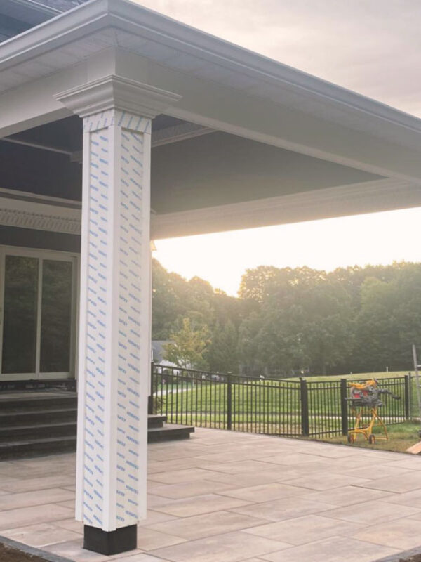 Outdoor patio area with new columns and stone tile flooring