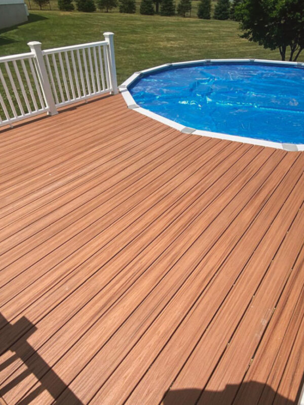 Completed pool deck with composite wood and white railing